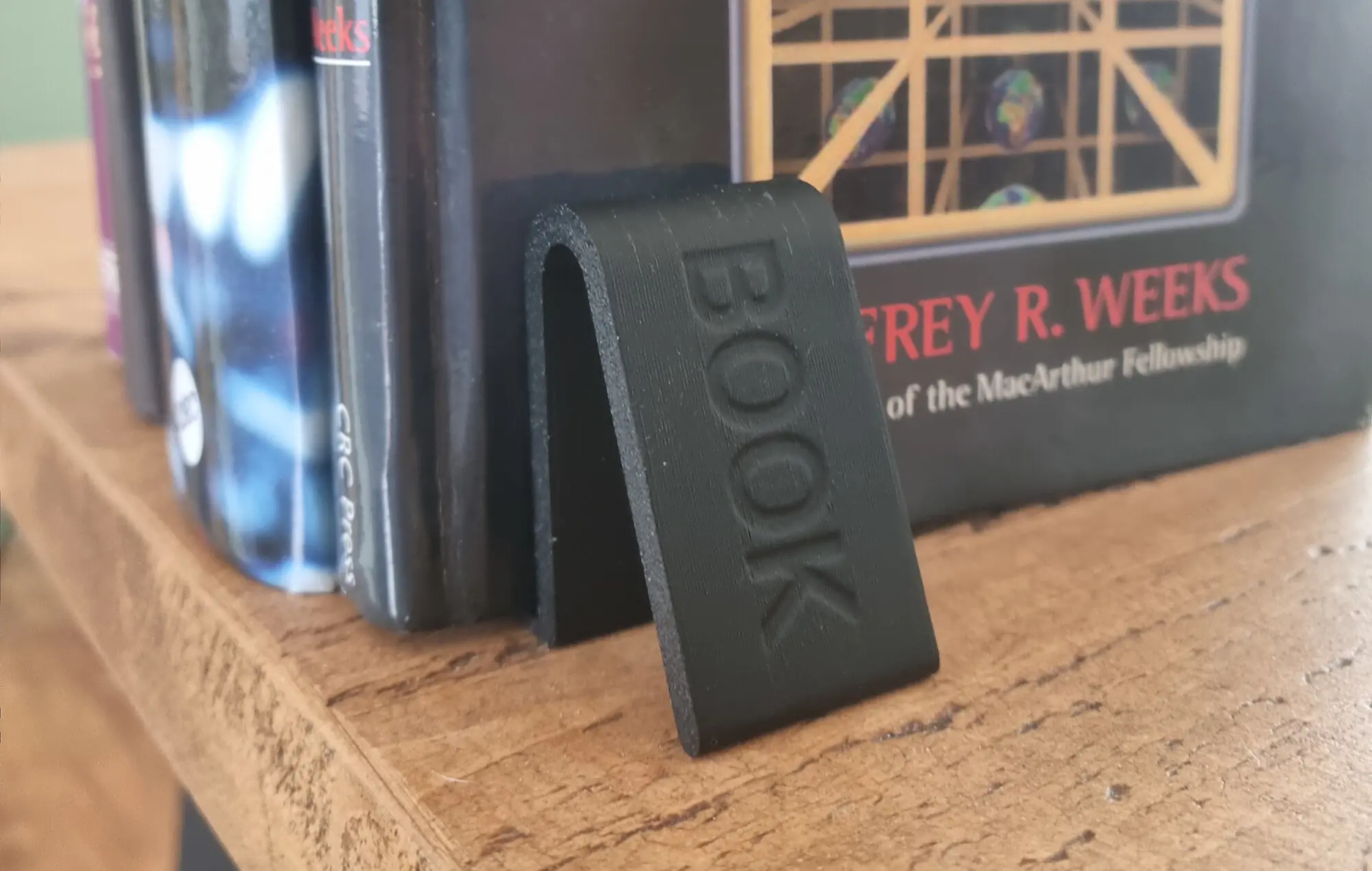 Book end holding a row of books